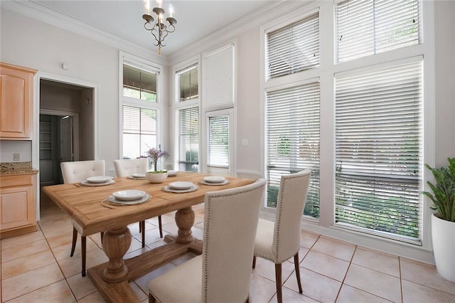 dining area featuring ornamental molding, light tile patterned floors, and a chandelier