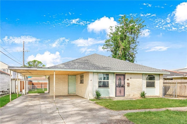 ranch-style house featuring a carport and a front lawn