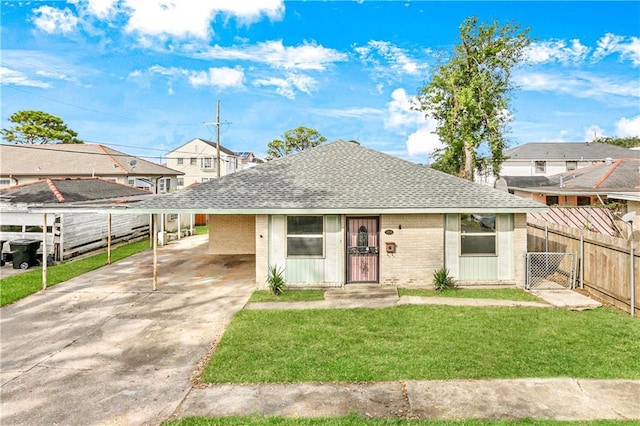 view of front of property with a front lawn and a carport