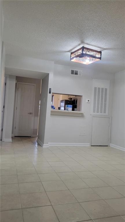 unfurnished room featuring a textured ceiling