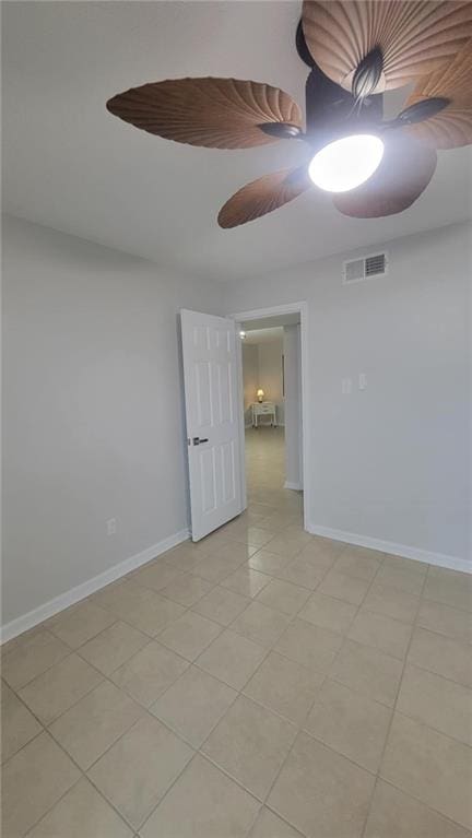 unfurnished room with light tile patterned floors and ceiling fan