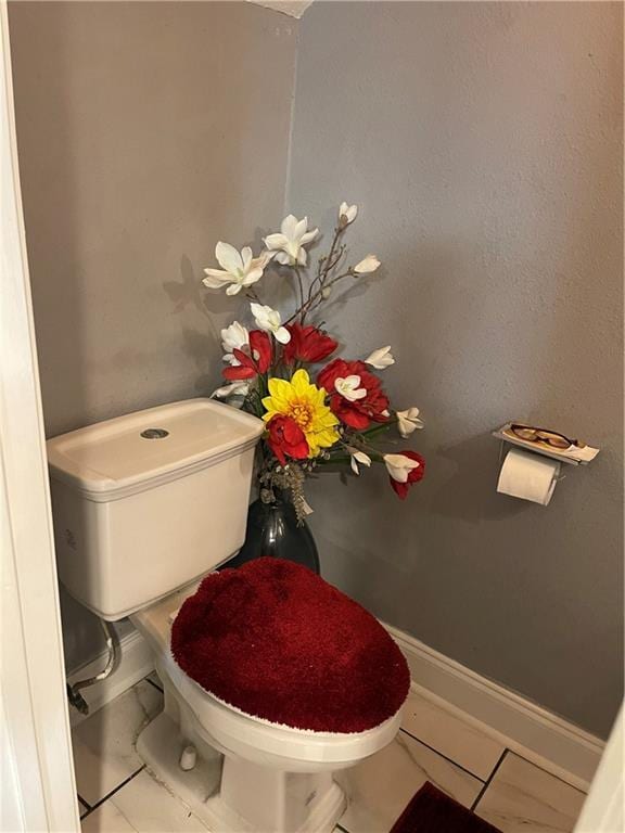 bathroom with tile patterned floors and toilet