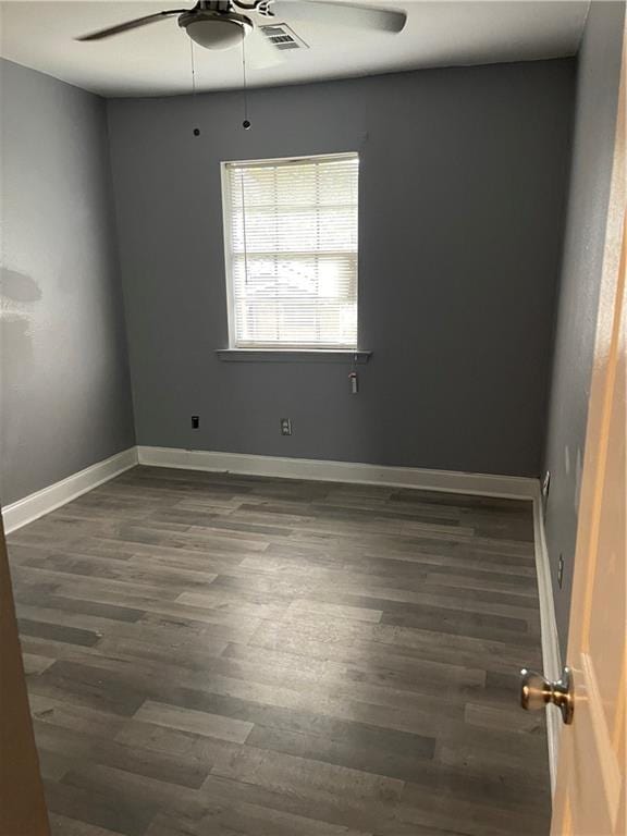 empty room featuring ceiling fan and dark hardwood / wood-style floors