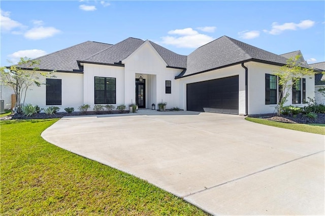 view of front facade with a garage, a front lawn, and central AC unit