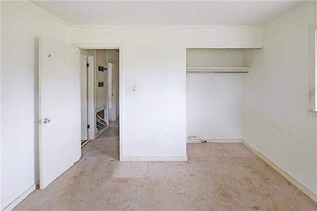 unfurnished bedroom featuring a closet and crown molding