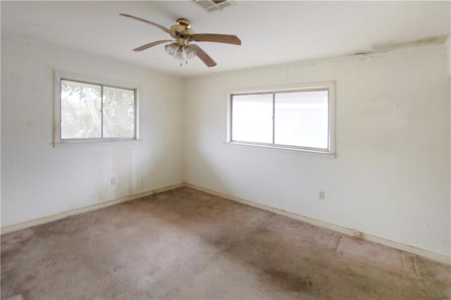 spare room featuring ceiling fan and carpet flooring