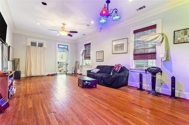 2301 Dauphine St, New Orleans, LA 70117 - living room with crown molding, wood-type flooring, and a wealth of natural light