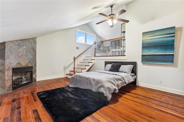 2301 Dauphine St, New Orleans, LA 70117 - bedroom featuring wood-type flooring, high vaulted ceiling, ceiling fan, and a fireplace