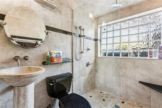 2301 Dauphine St, New Orleans, LA 70117 - bathroom with a tile shower and tile walls