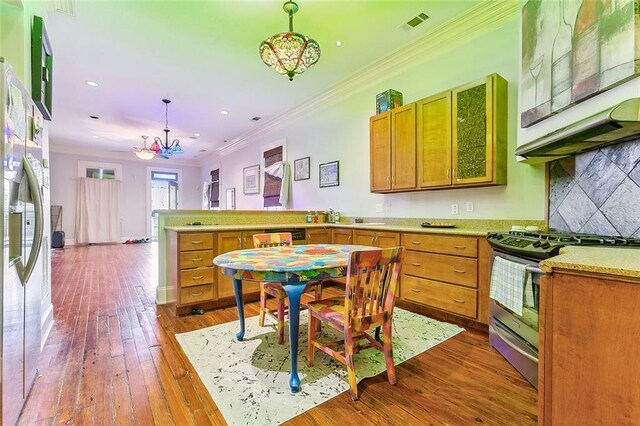 2301 Dauphine St, New Orleans, LA 70117 - kitchen with hanging light fixtures, stainless steel range, crown molding, dark wood-type flooring, and fridge with ice dispenser