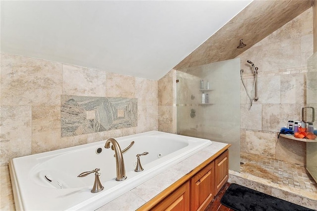 2301 Dauphine St, New Orleans, LA 70117 - bathroom featuring lofted ceiling, tile walls, and separate shower and tub