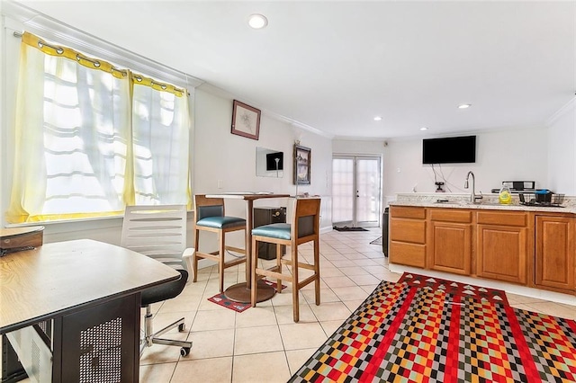 2301 Dauphine St, New Orleans, LA 70117 - kitchen with crown molding, sink, and light tile patterned floors