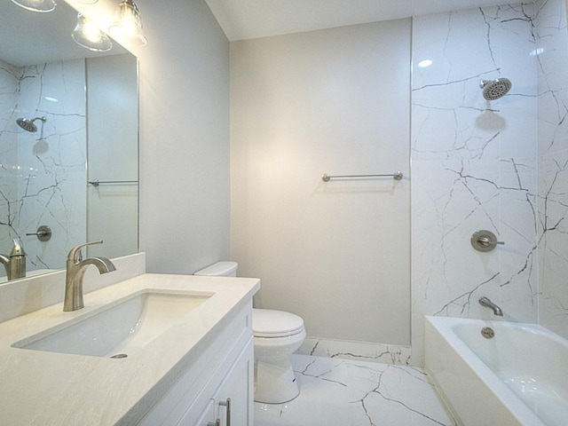 full bathroom featuring toilet, vanity, and tiled shower / bath