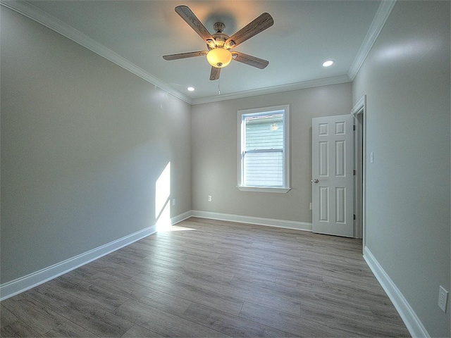 unfurnished room with ceiling fan, crown molding, and light hardwood / wood-style floors