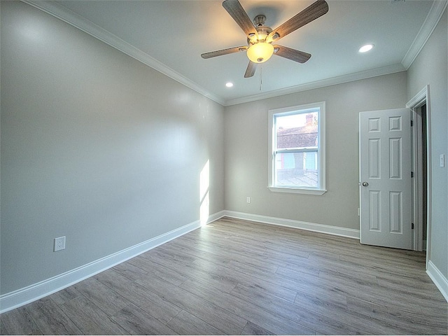 empty room with ceiling fan, ornamental molding, and light hardwood / wood-style flooring