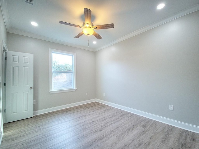 spare room with ceiling fan, crown molding, and light hardwood / wood-style flooring