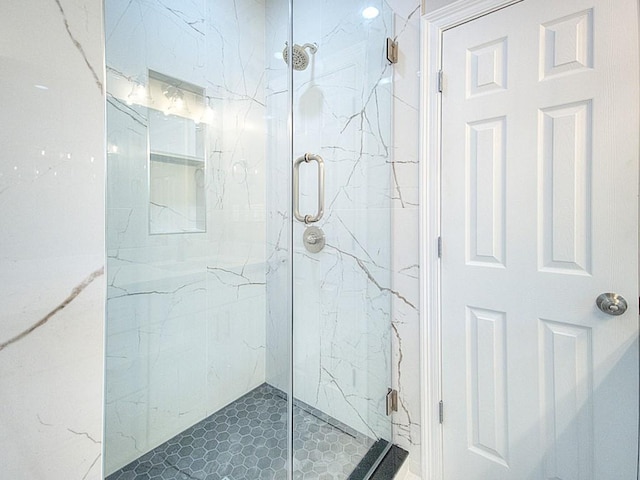 bathroom with a shower with door