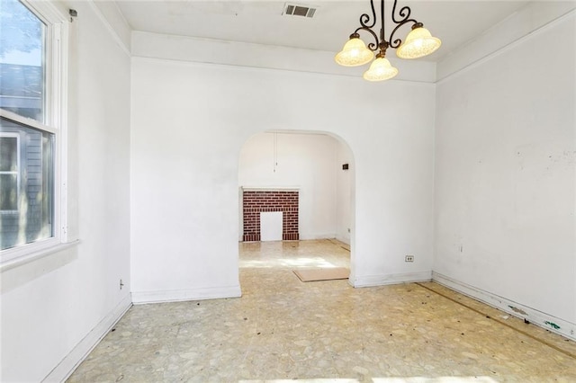 unfurnished room featuring a notable chandelier