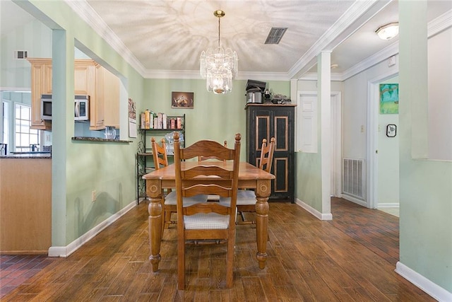 dining room with ornamental molding and dark hardwood / wood-style flooring