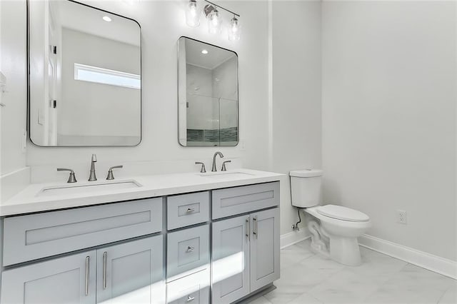 bathroom featuring toilet, vanity, and walk in shower