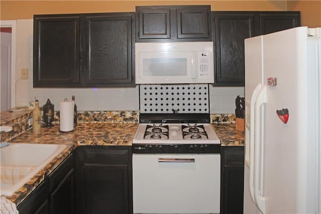 kitchen with sink, backsplash, and white appliances