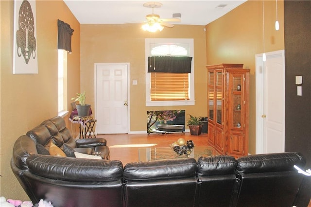 living room featuring ceiling fan and a healthy amount of sunlight