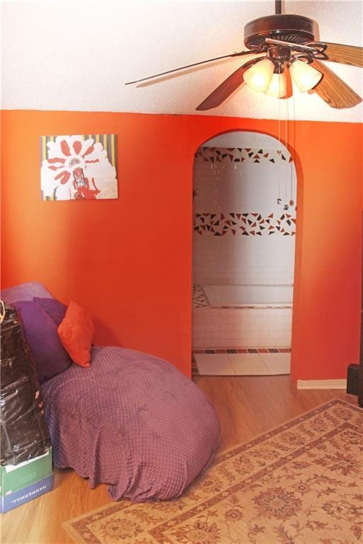 bedroom with ceiling fan and wood-type flooring