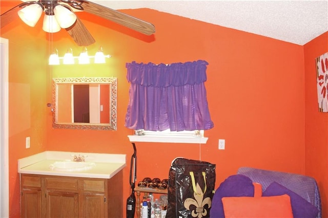 bathroom featuring ceiling fan, a textured ceiling, and vanity