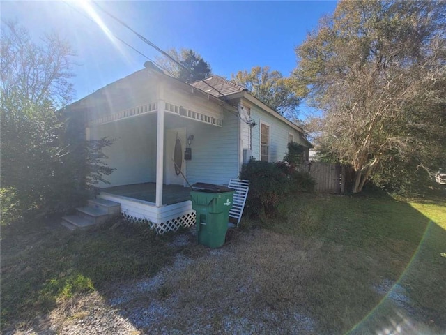 view of side of home with a lawn