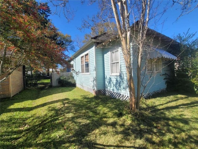 view of property exterior with a yard