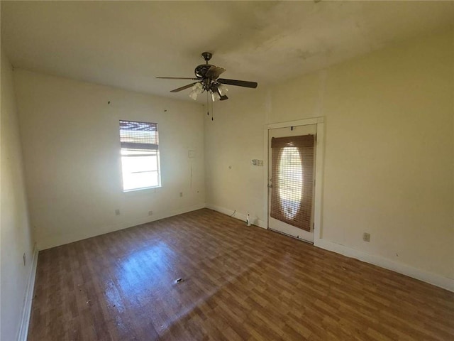 unfurnished room featuring ceiling fan and dark wood-type flooring