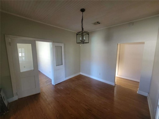 unfurnished dining area with dark hardwood / wood-style flooring, wood ceiling, a chandelier, and ornamental molding