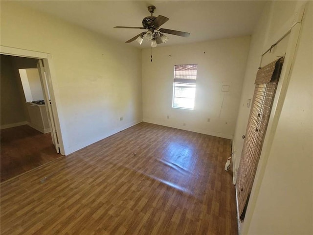 unfurnished bedroom with ceiling fan and dark hardwood / wood-style floors