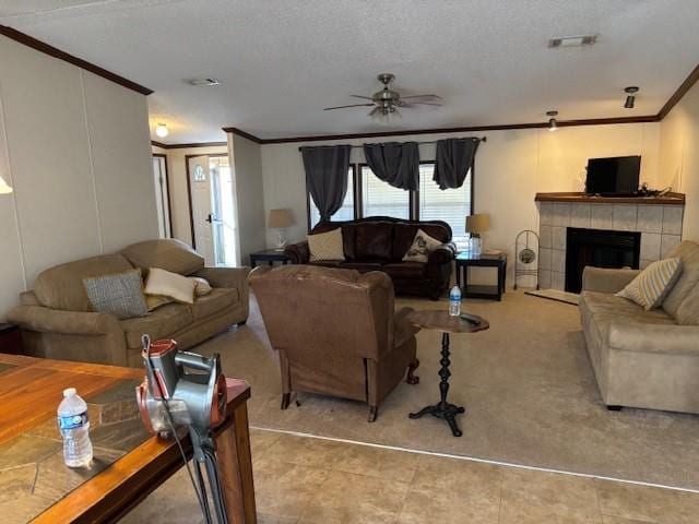 169 Pump Station Rd, Venice, LA 70091 - living room with crown molding, ceiling fan, a tile fireplace, and a textured ceiling