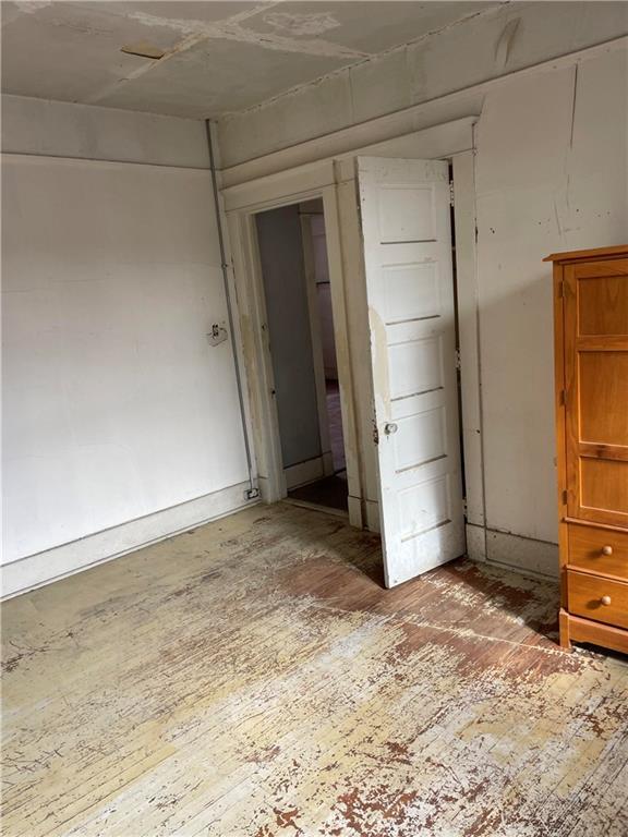 unfurnished room featuring hardwood / wood-style flooring