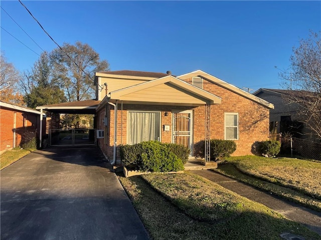 view of front of property with a front yard and a carport