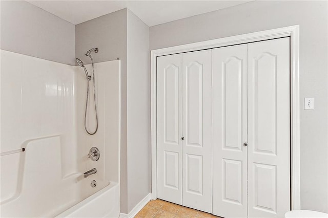 bathroom with tile patterned floors and bathtub / shower combination