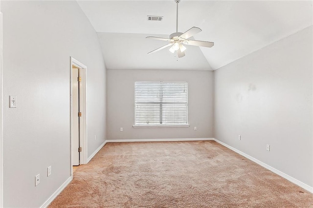 empty room with light carpet, vaulted ceiling, and ceiling fan