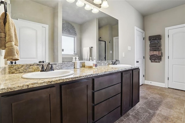 bathroom with a shower with shower door and vanity