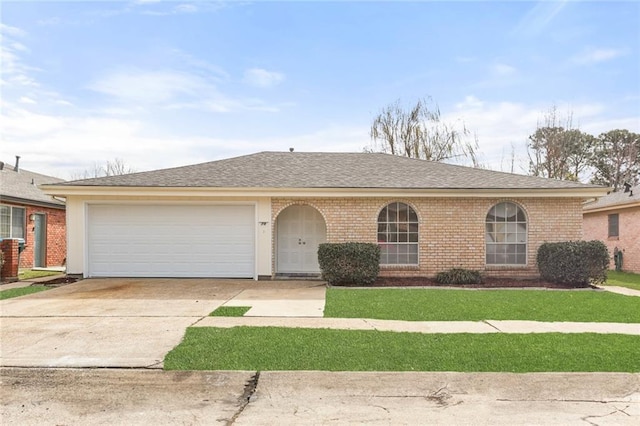 ranch-style house with brick siding, a shingled roof, a garage, driveway, and a front lawn