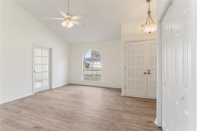 entrance foyer featuring lofted ceiling, light wood-type flooring, a ceiling fan, and baseboards