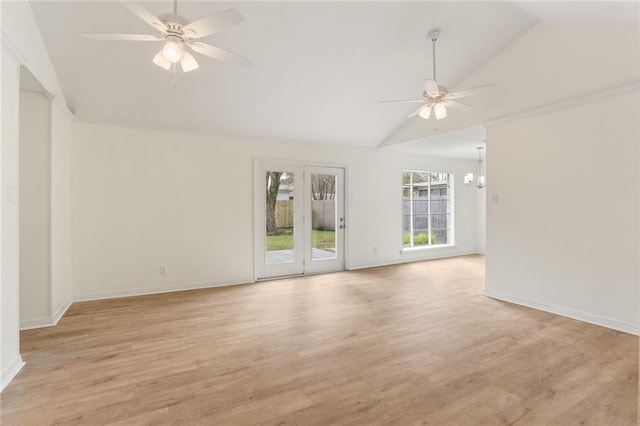 empty room with lofted ceiling, light wood-style flooring, and ceiling fan with notable chandelier