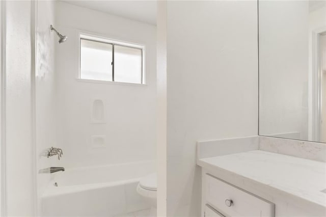 bathroom with tub / shower combination, vanity, and toilet