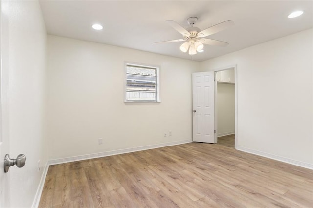 unfurnished bedroom with a ceiling fan, recessed lighting, light wood-style flooring, and baseboards