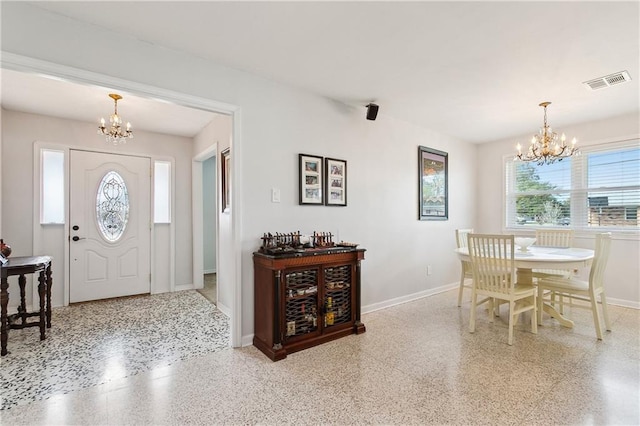 dining space with an inviting chandelier