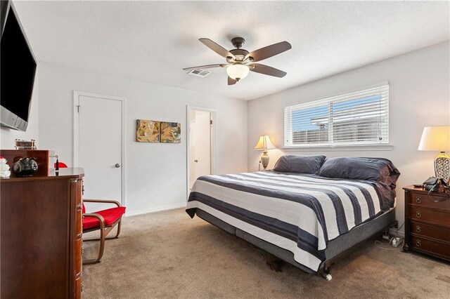 bedroom featuring ceiling fan and light colored carpet