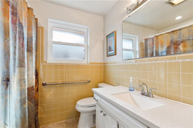 bathroom with toilet, tile walls, a shower with curtain, and vanity