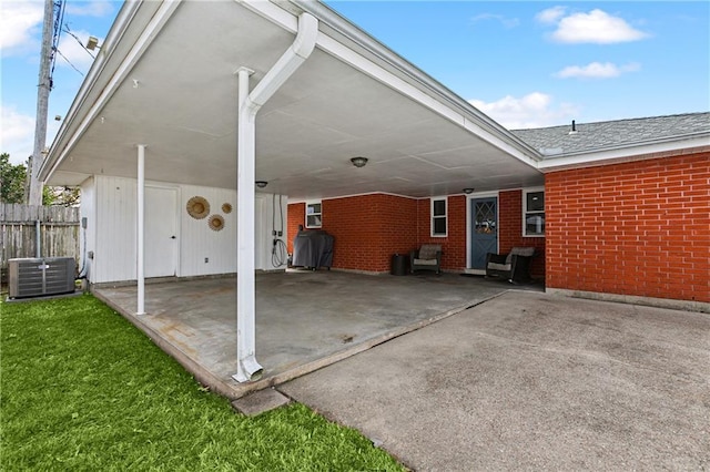 view of patio / terrace featuring central AC unit, area for grilling, and a carport