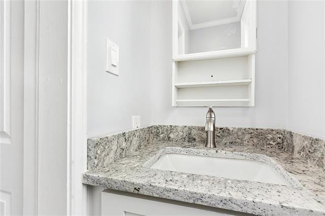 bathroom featuring ornamental molding and vanity