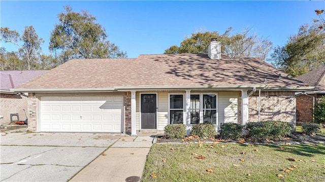 view of front of home with a garage and a front lawn